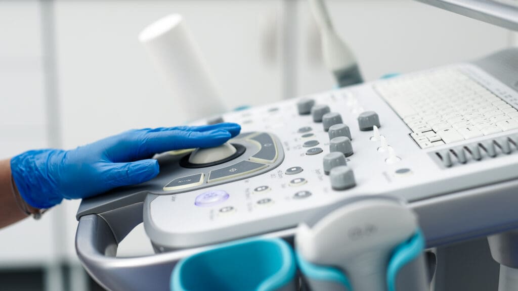 Close-up of ultrasound equipment with a probe in a modern diagnostic center. The concept of precision and advanced technology in professional medicine.