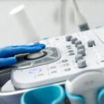 Close-up of ultrasound equipment with a probe in a modern diagnostic center. The concept of precision and advanced technology in professional medicine.