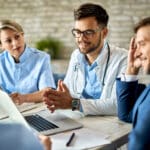 Team of doctors and businessman using computer during the meeting in the office.